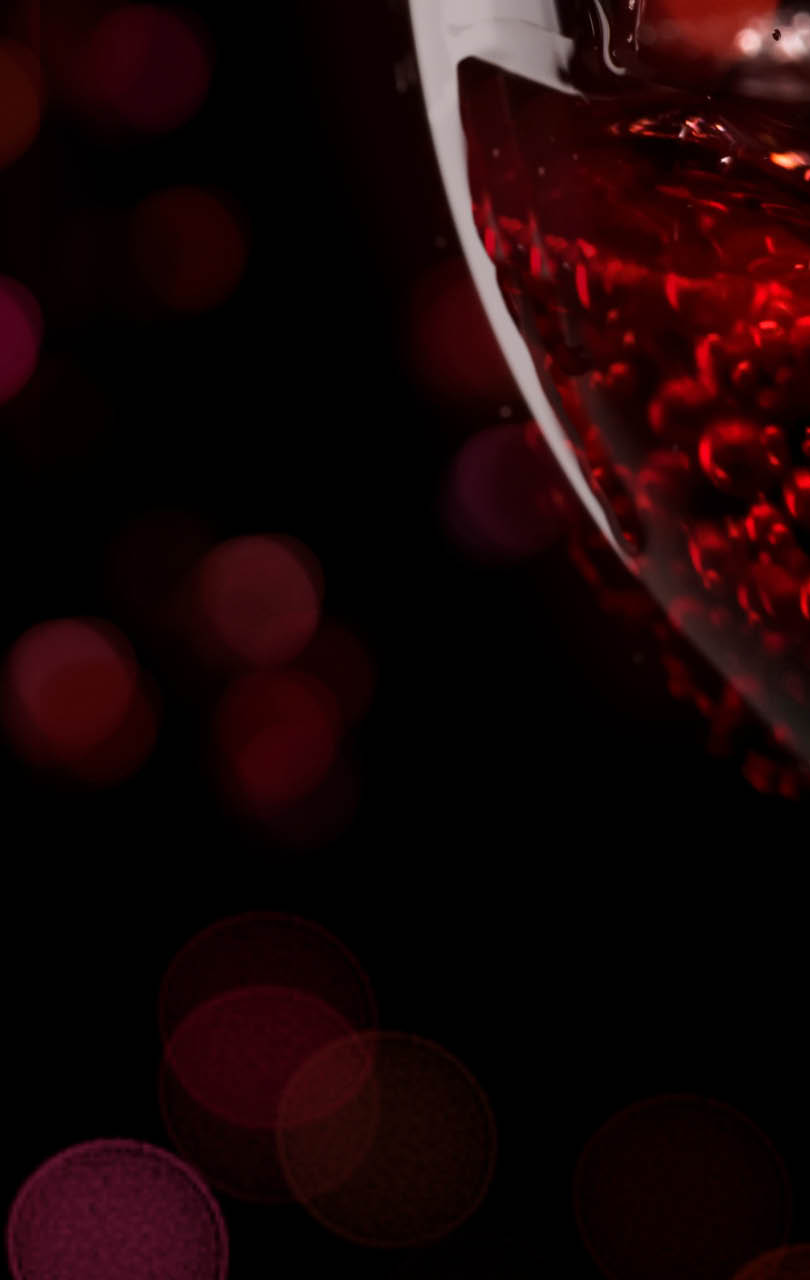 Red wine on black background, abstract splashing. Panoramic banner with copy space
